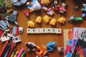 Toys and the word friend on a table