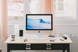 A well organized deskwith a computer and various gadgets