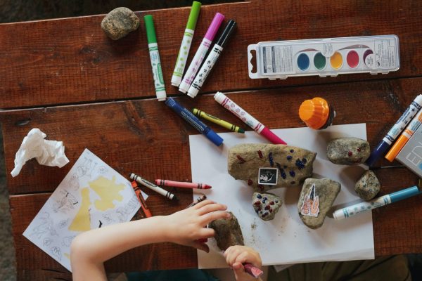 Crayons and markers on a brown desk