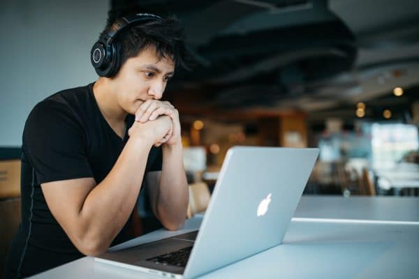 Man diligently learning from a laptop