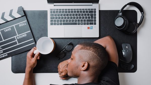 Tired man resting face on desk