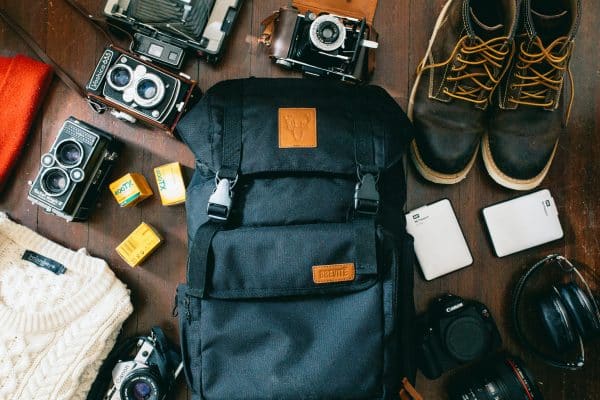 Various backpacking items sprawled out on table.