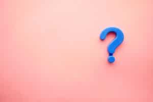 Blue question mark against salmon pink background.